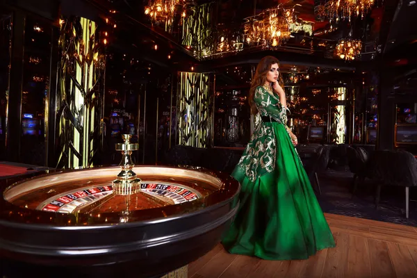 A professional dealer in a tuxedo greeting players at the roulette table, symbolizing the authentic live casino feel at JDLOVE.