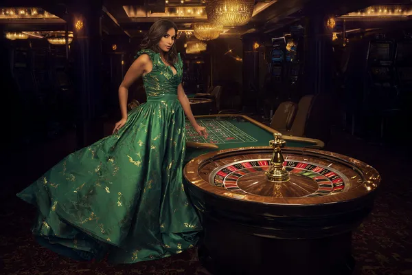 A man celebrating a winning moment on his laptop while gaming symbols float around him, capturing the excitement of JDLOVE games.