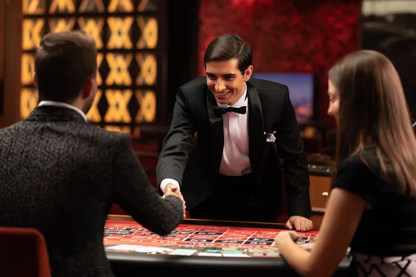 A woman in a luxurious green gown next to an ornate roulette wheel, capturing the upscale casino mood of JDLOVE.